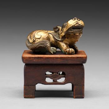 511. A small gilt bronze figure of a buddhist lion, Qing dynasty (1644-1912).