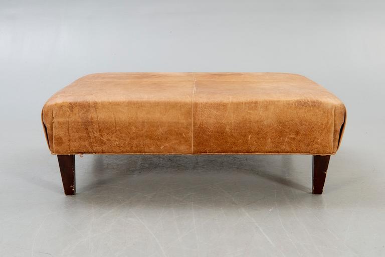 A leather ottoman/coffee table alter part of the 20th century.