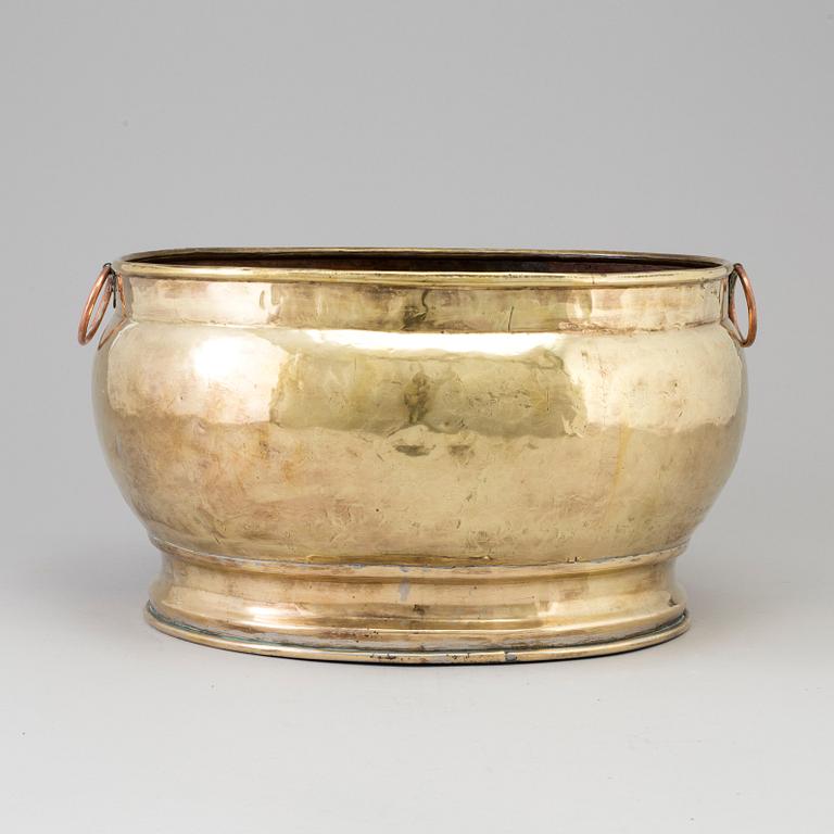 A 18th century brass champagne cooler.