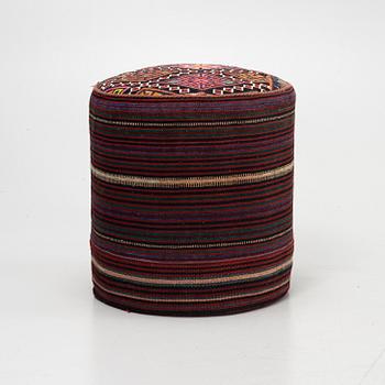 A Kelim covered stool.