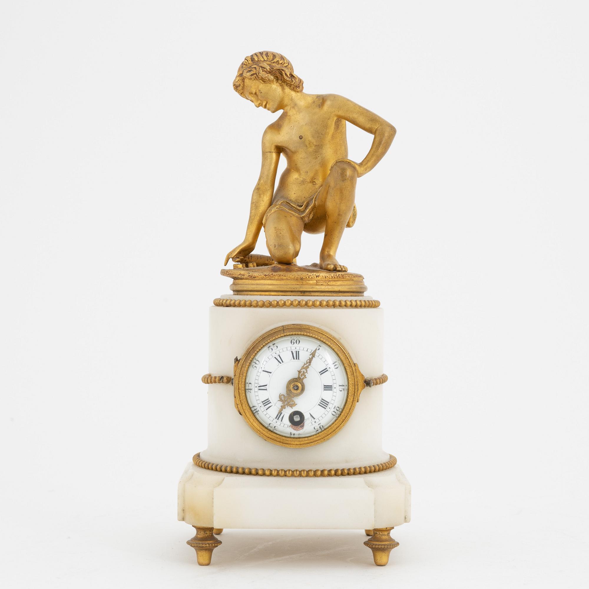 A Louis XVI-style marble and ormolu mantel clock, late 19th Century.