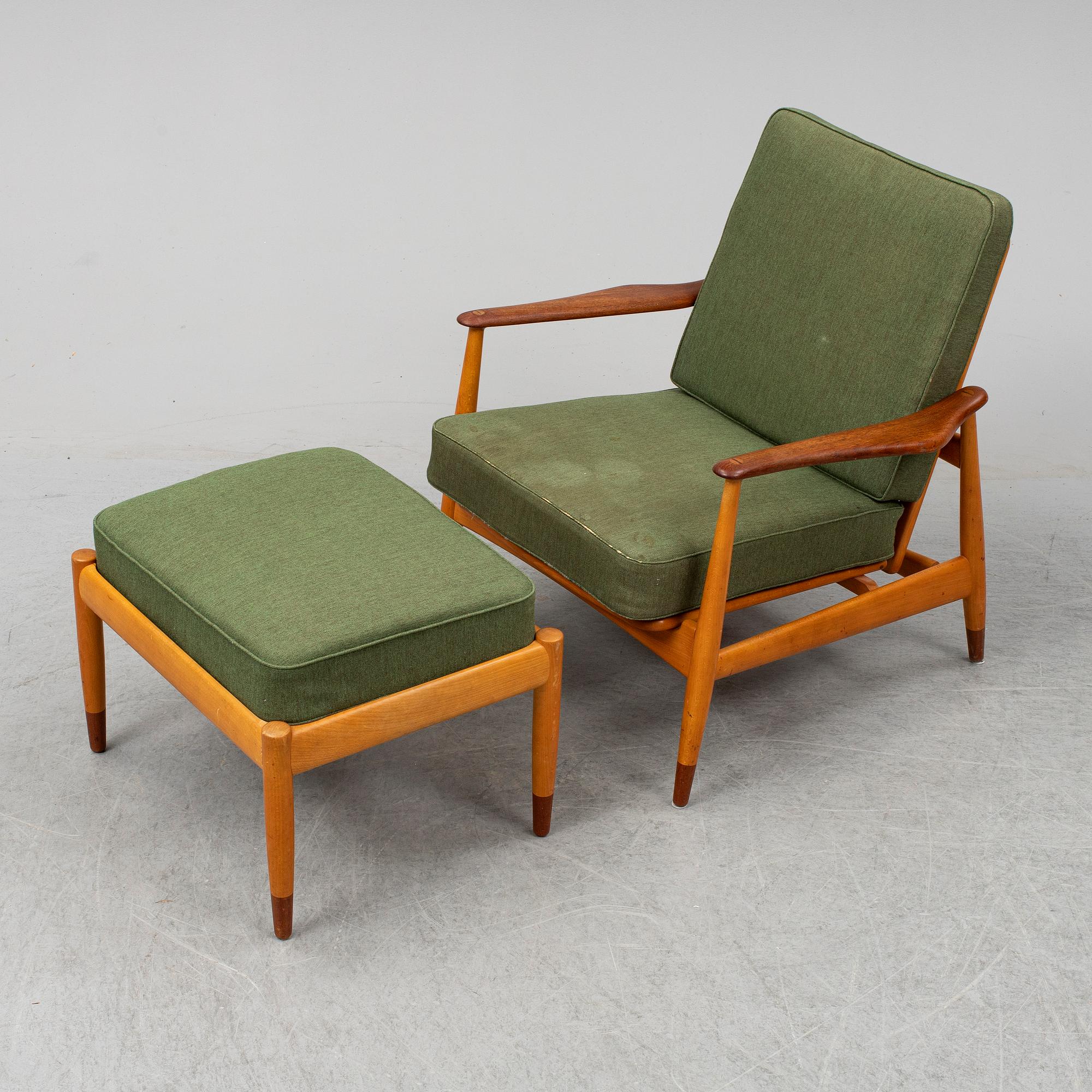 A 1950's beech and teak model FD 161 easy chair with stool by Arne Vodder for France & Son.