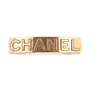 CHANEL, a gold colored metall hair clip.