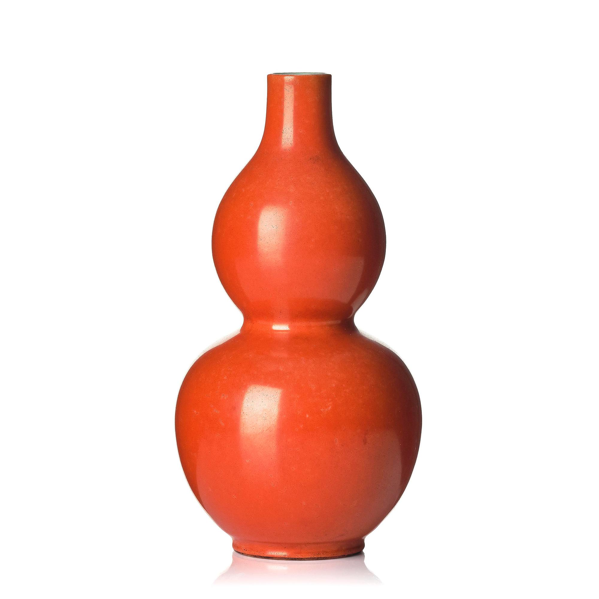A coral red-enameled double-gourd vase, Qing dynasty with Jiaqing mark (1796-1820).