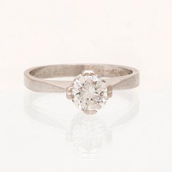 An 18K white gold solitaire ring set with a round brilliant cut diamond.