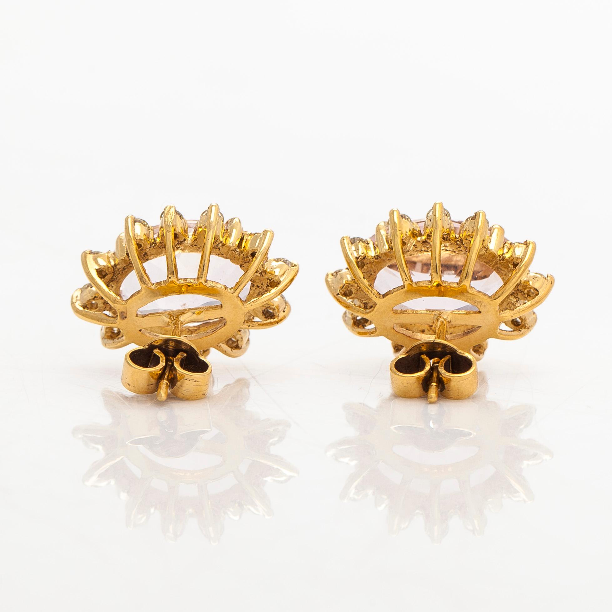 A pair of 14K gold earrings with faceted morganites and brilliant-cut diamonds.