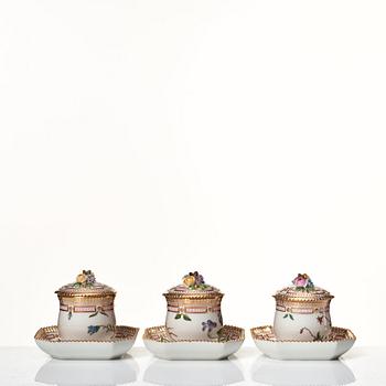 A set of 12 Royal Copenhagen 'Flora Danica' custard cups with covers and stands, Denmark, 20th Century.