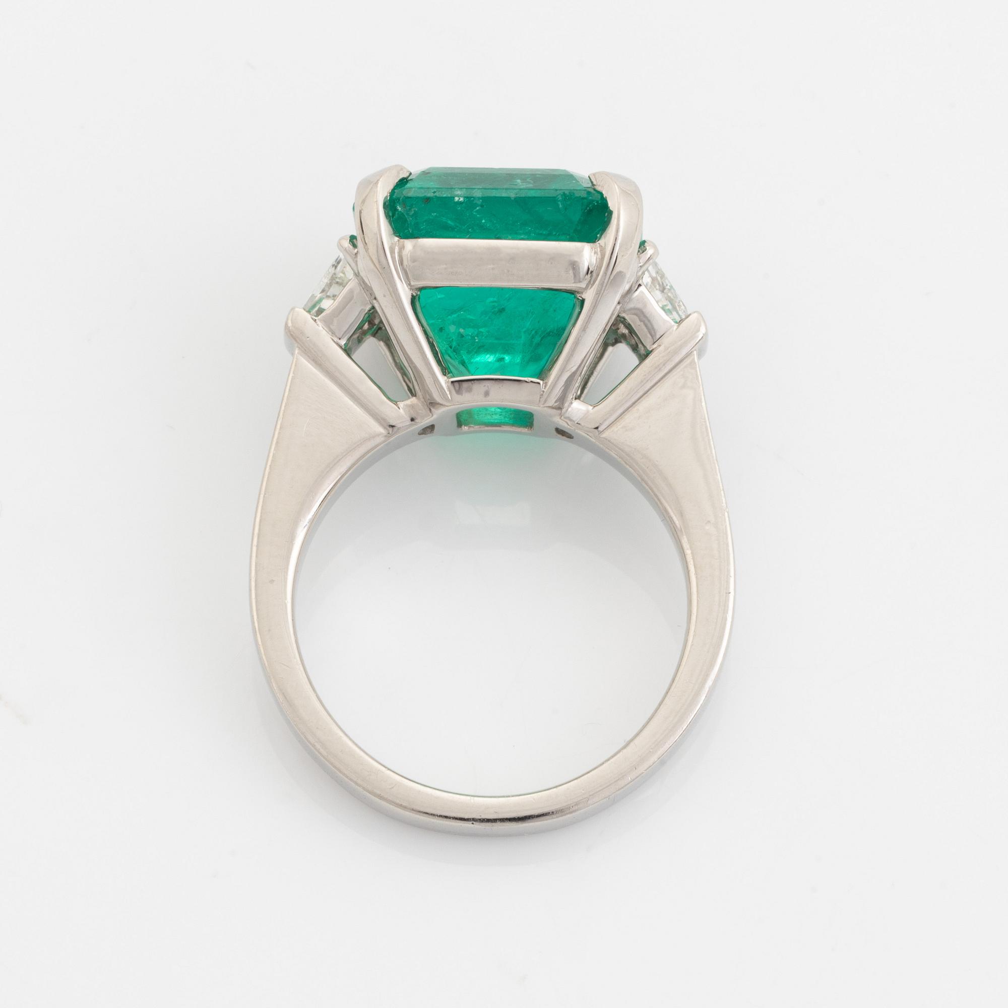 Emerald and trapezoid cut diamond ring.