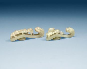Two pale green nephrite garment hooks, Qing dynasty.