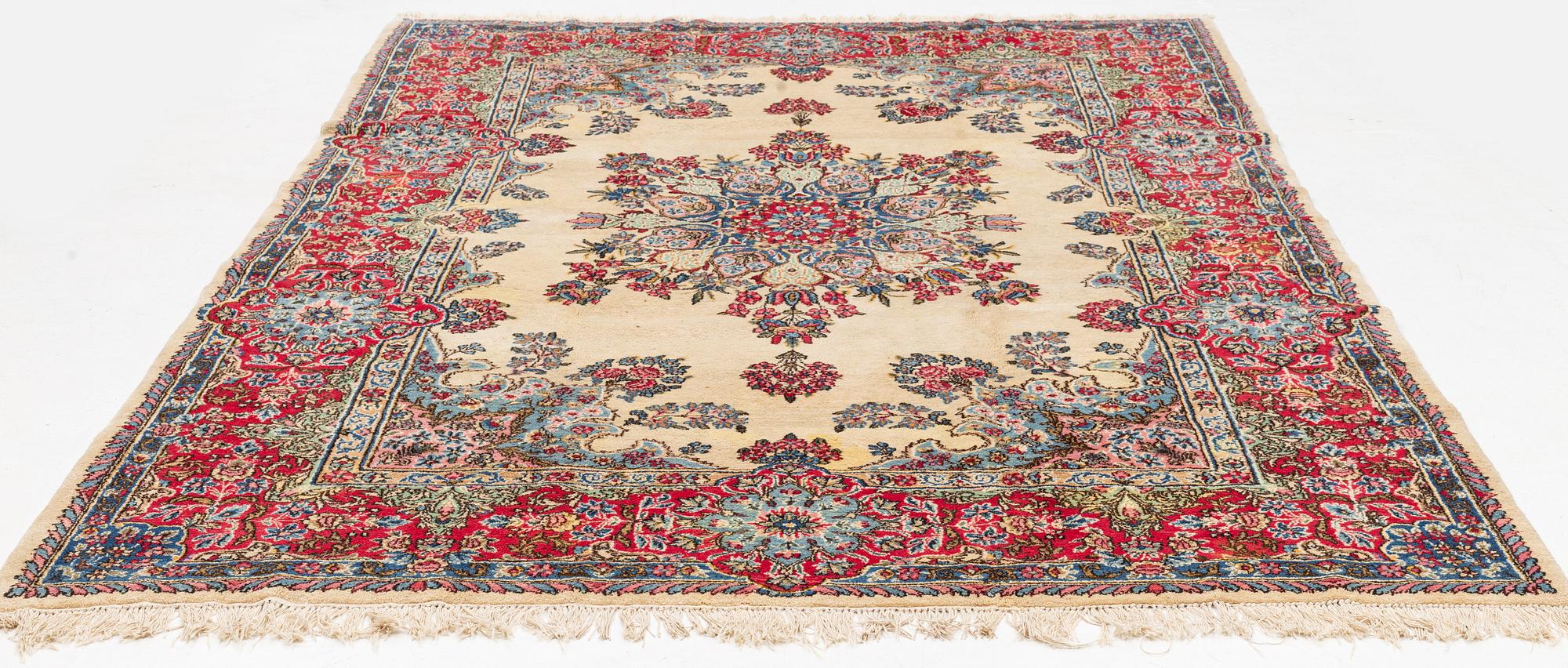A carpet, old Kerman, approx. 314 x 210 cm.