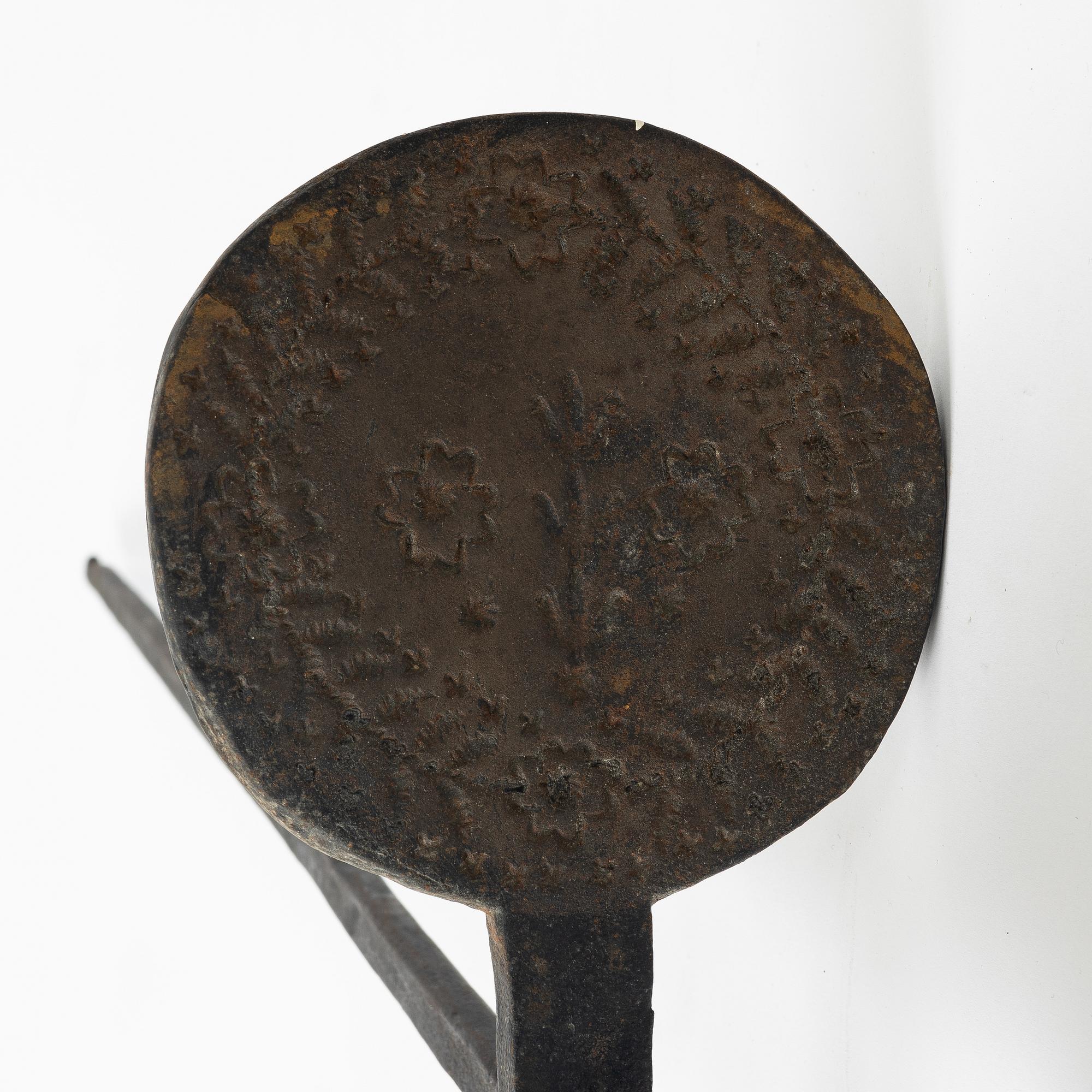 An iron wafer maker, dated 1662.