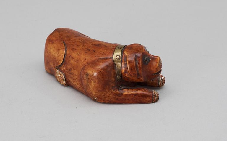 A 19th-20th century birch snuffbox in the shape of a lying dog.