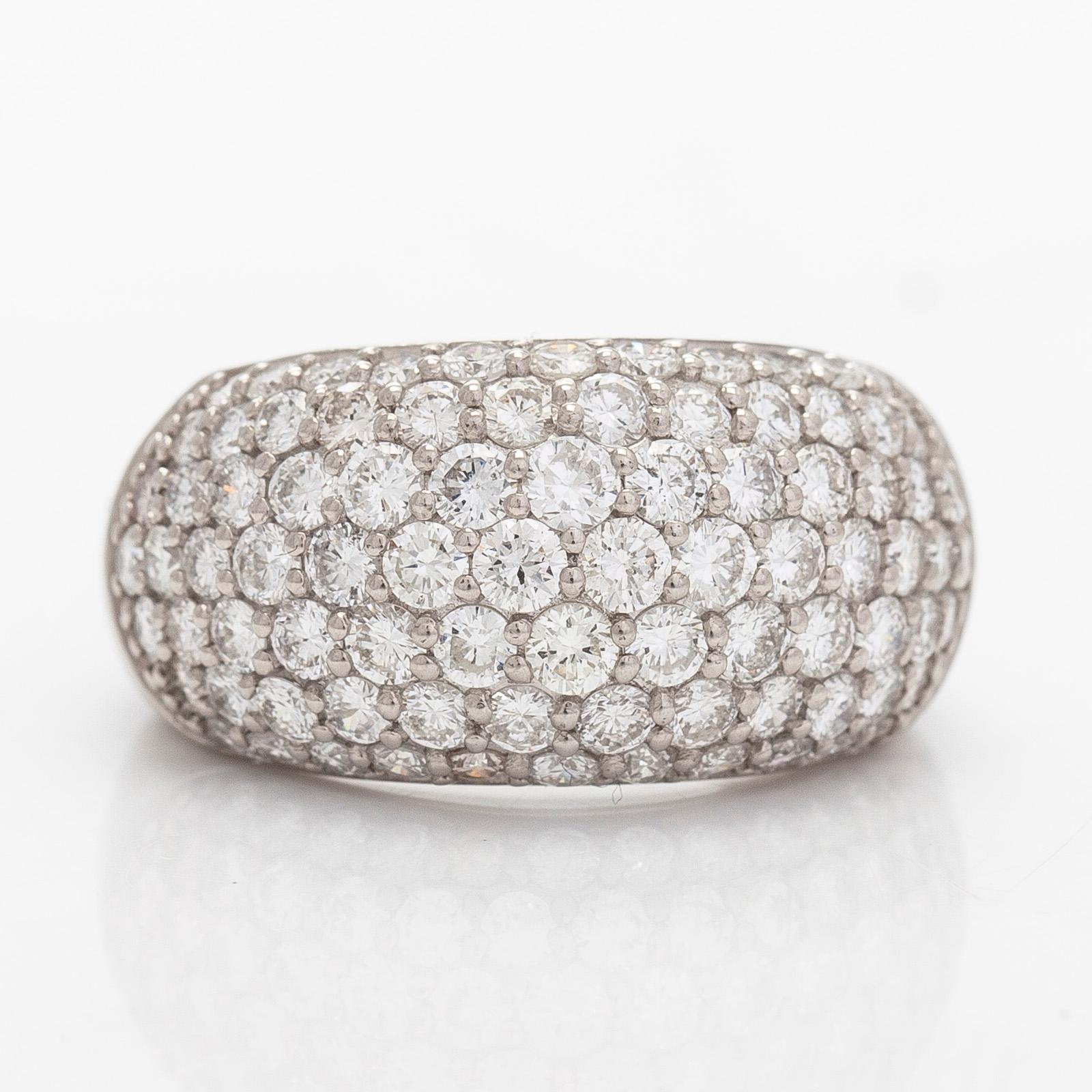 A platinum bombé ring with brilliant-cut diamonds.