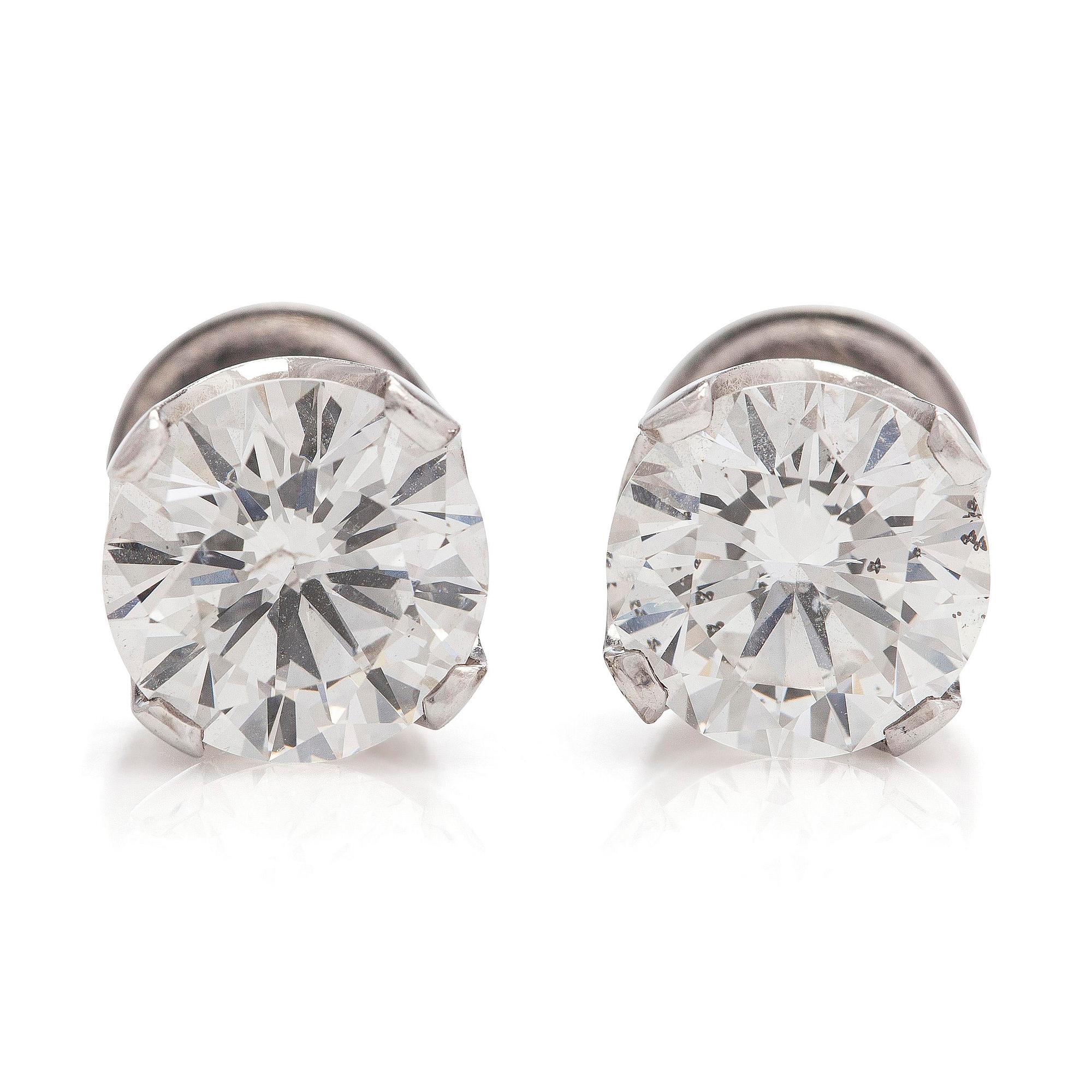 A pair of brilliant-cut diamond stud earrings in 18K white gold.