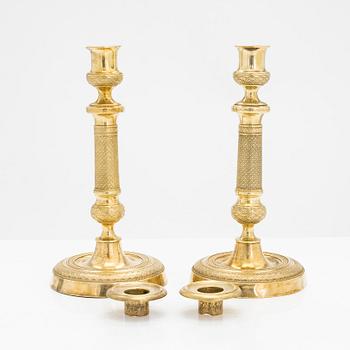 A pair of early 19th century French gilded Empire candlesticks.