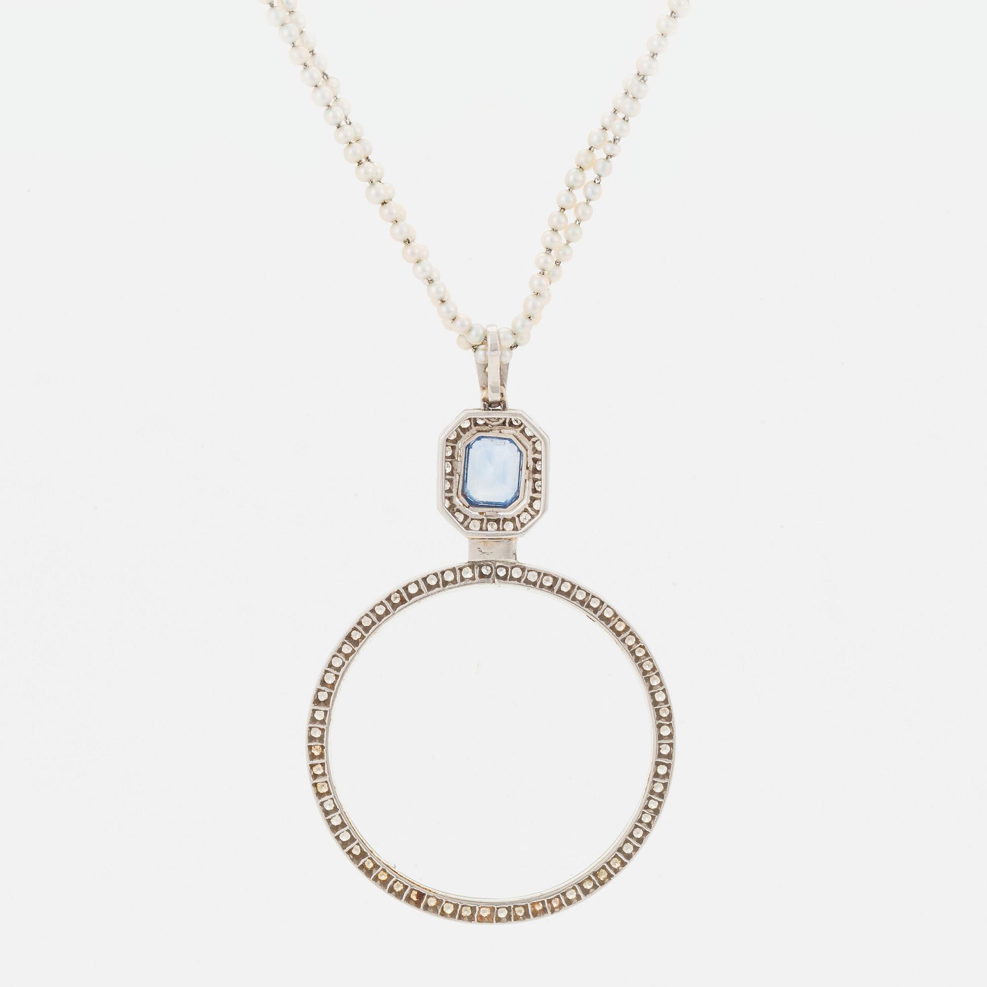 A platinum lorgnette set with a faceted sapphire and rose-cut diamonds.