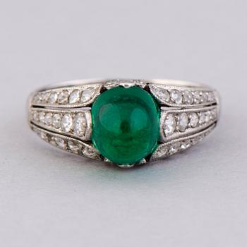 A RING, cabochon cut emerald, old cut diamonds. Alexander Tillander, St Petersburg 1855-1918.