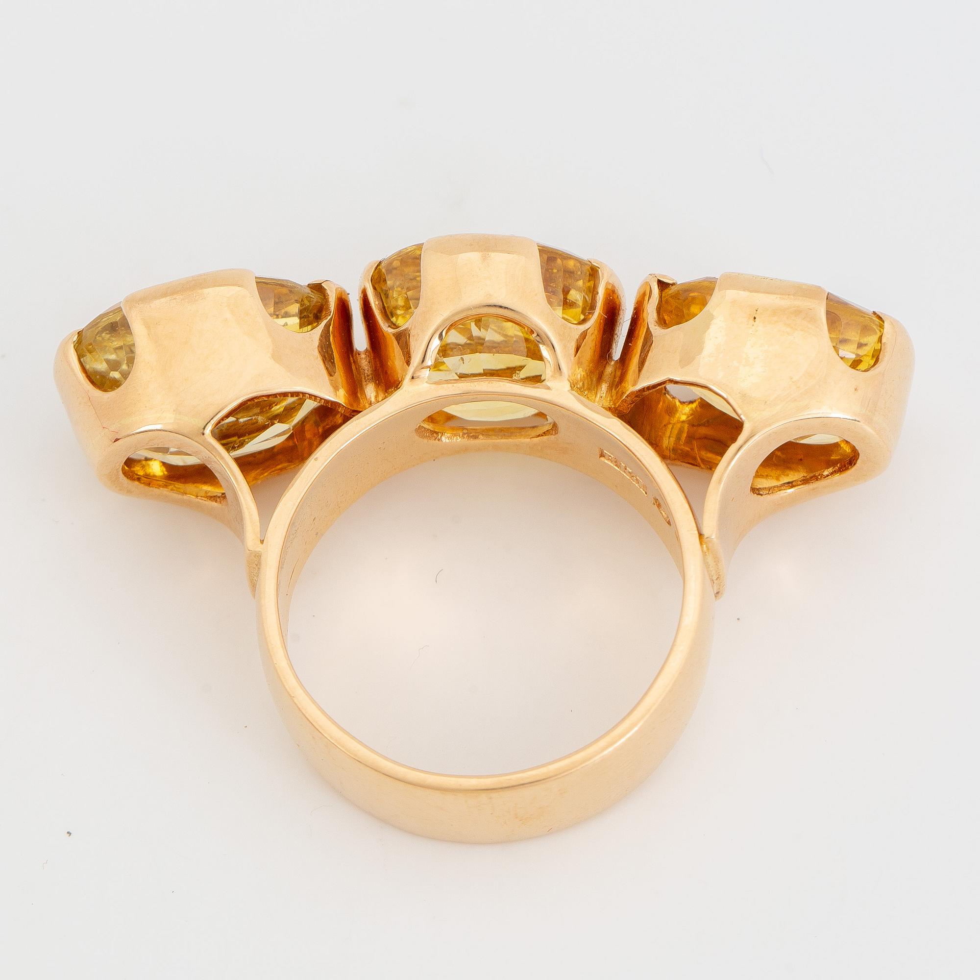 18K gold and yellow sapphire three-stone ring.