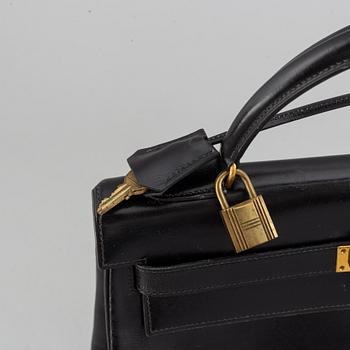 Hermès,a black leather 'Kelly 32' handbag, 1975.