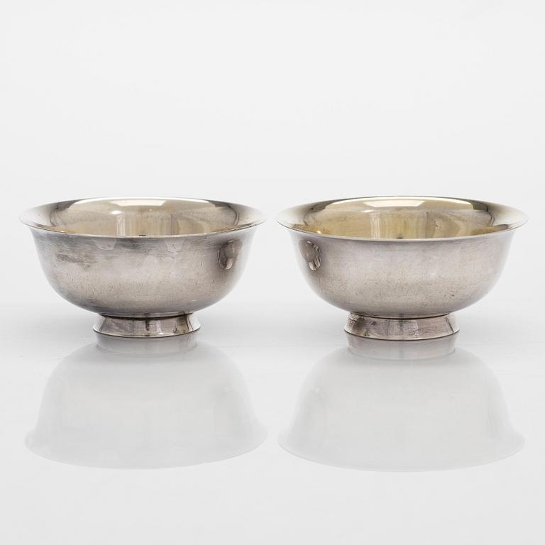 Six silver cups in case, China. Mid 20th century.