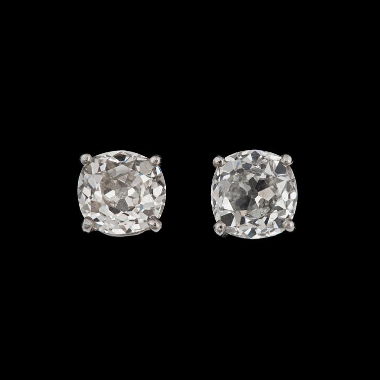 A pair of old-cut diamond studs. Total carat weight circa 3.26 cts. Quality circa G-H/VS.