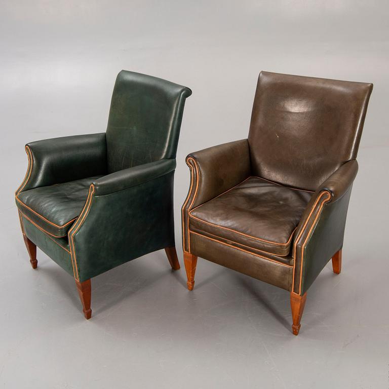 A set of two leather armchairs lat er part of the 20th century.