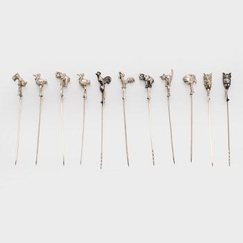 A set of twelve silver coasters and cocktail sticks 11 pcs,  Suomen Kultaseppä Oy 1935 and Kultakeskus 1983.