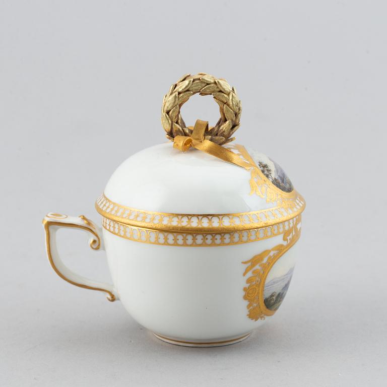 A 19th century Meissen miniature lidded porcelain cup decorated with views of Mainau.