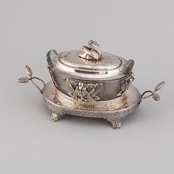 An 'Egyptian Empire style' silver plated caviar bowl with a blasted glass canister, ca 1900.