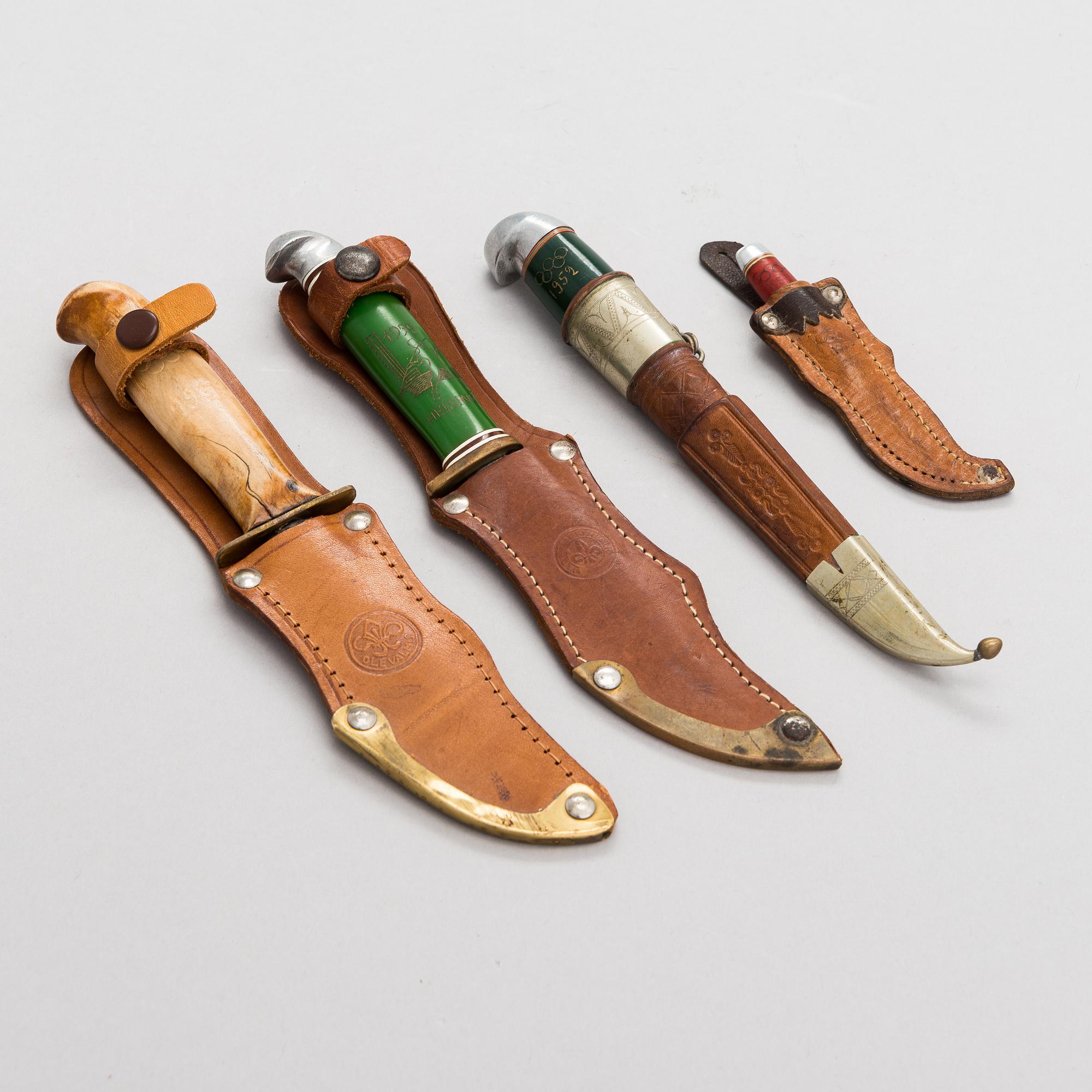 A set of four puukko knives and leather sheats, marked Olympia Helsinki -52.