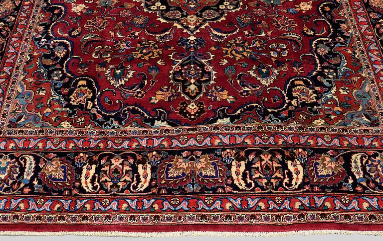 A carpet Mashad, signed, around 290 x 245 cm.