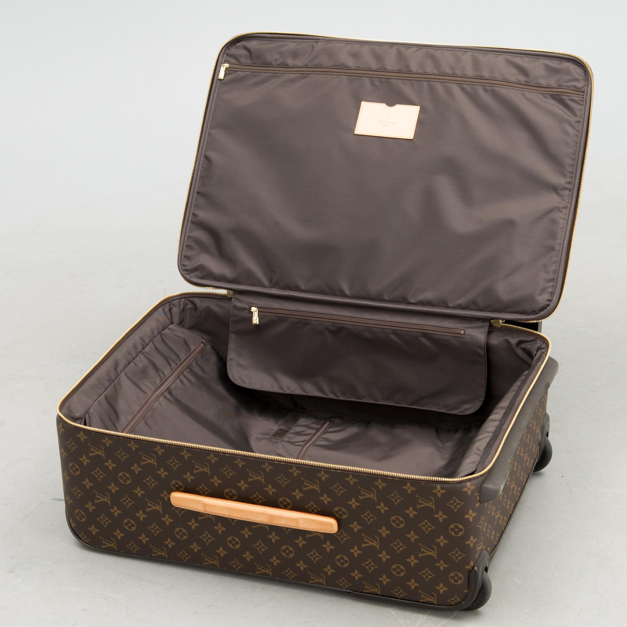 A Monogram Canvas Pégase 65 Suitcase with a Protective Cover.