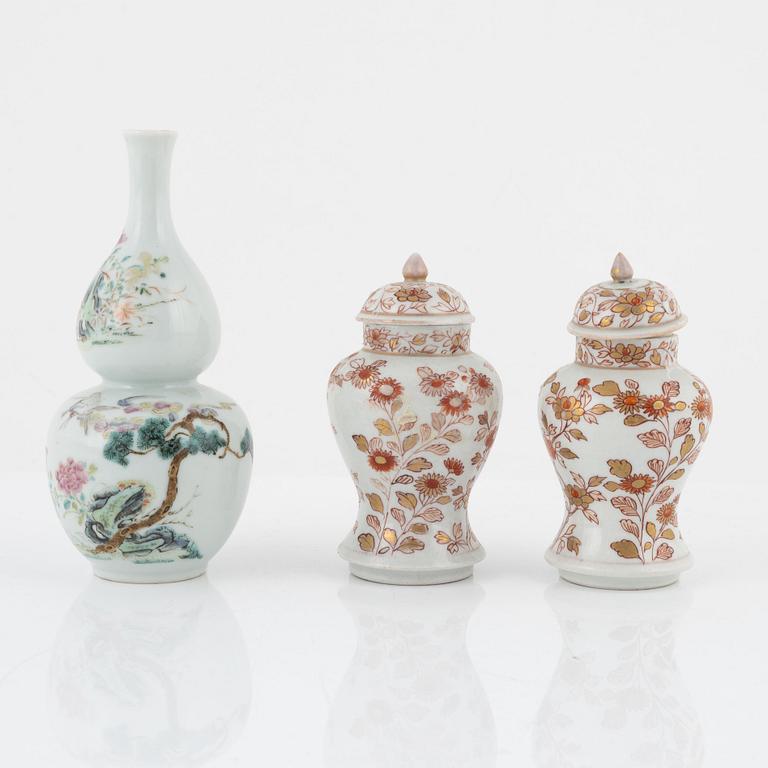 A pair of Kangxi urns, China, early 18th century, and a gourd-shaped vase, China, late 19th century.