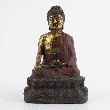 A Chinese cast iron figure of a Buddha, probably late Ming dynasty.