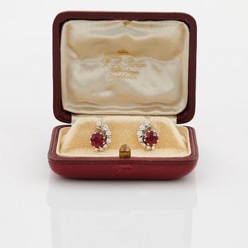 A pair of 18K white gold WA Bolin earrings set with faceted rubies and round brilliant- and eight-cut diamonds.