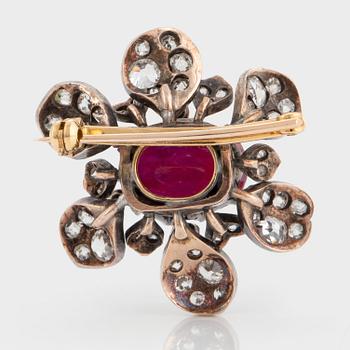 A brooch set with a cabochon-cut ruby ca 4.00 cts and old-cut diamonds.