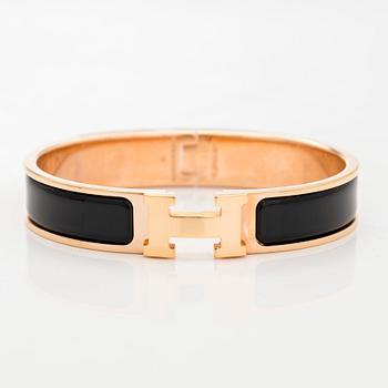 Hermès, a 'Clic H' bracelet.