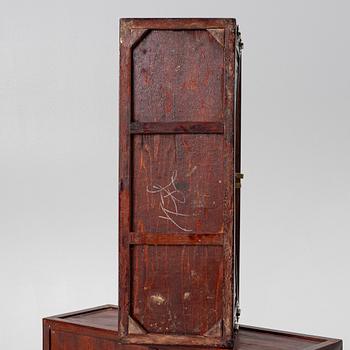 A small Chinese stained wood two part cabinet, 1900s.