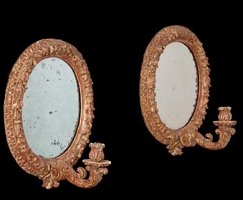 A pair of Swedish Baroque circa 1700 one-light girandole mirrors.