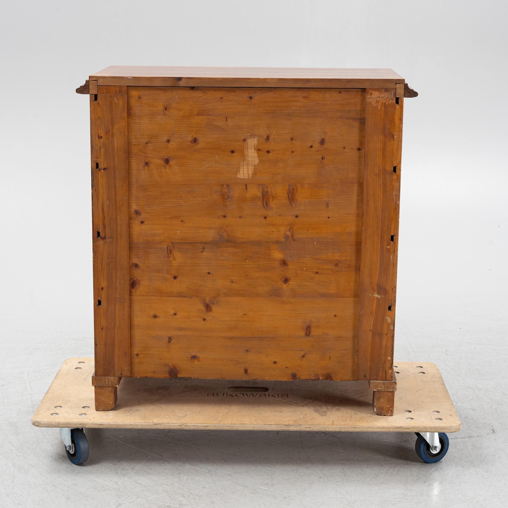 A walnut-veneered dresser, around 1900.