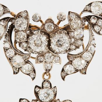 A 14K gold and silver brooch set with old-cut diamonds.