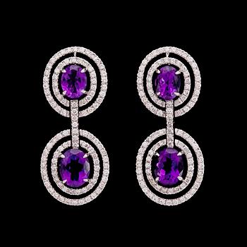 925. A pair of amethyst and brilliant cut diamond earrings, tot. 1.90 ct.