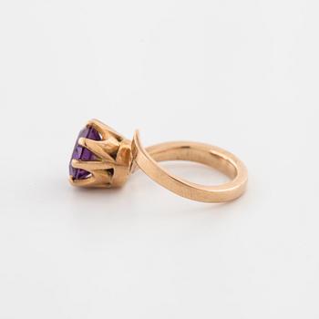 A synthetic color change sapphire ring.