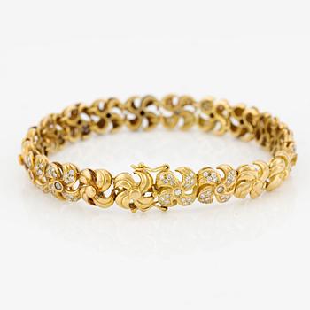 Armlänk, 18K guld med briljantslipade diamanter.