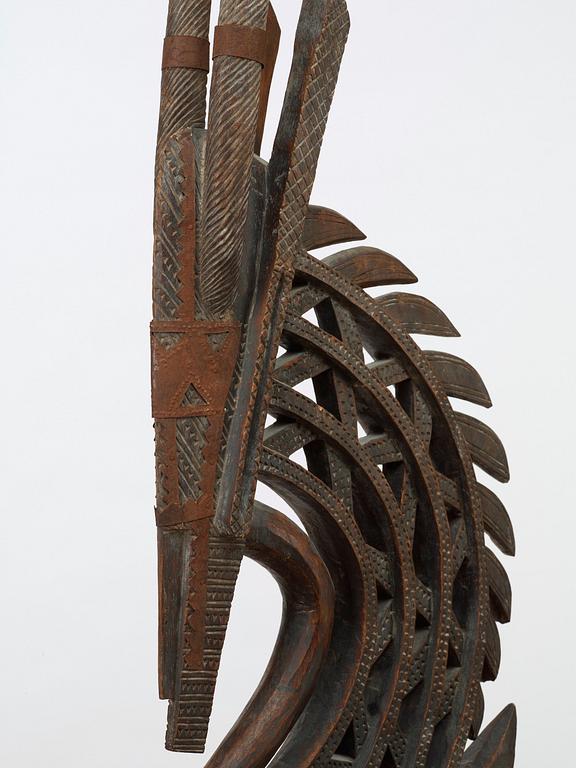 HEADDRESS. Tshiwara/Ciwara (stylized male antelope). Wooden sculpture with metal fittings.