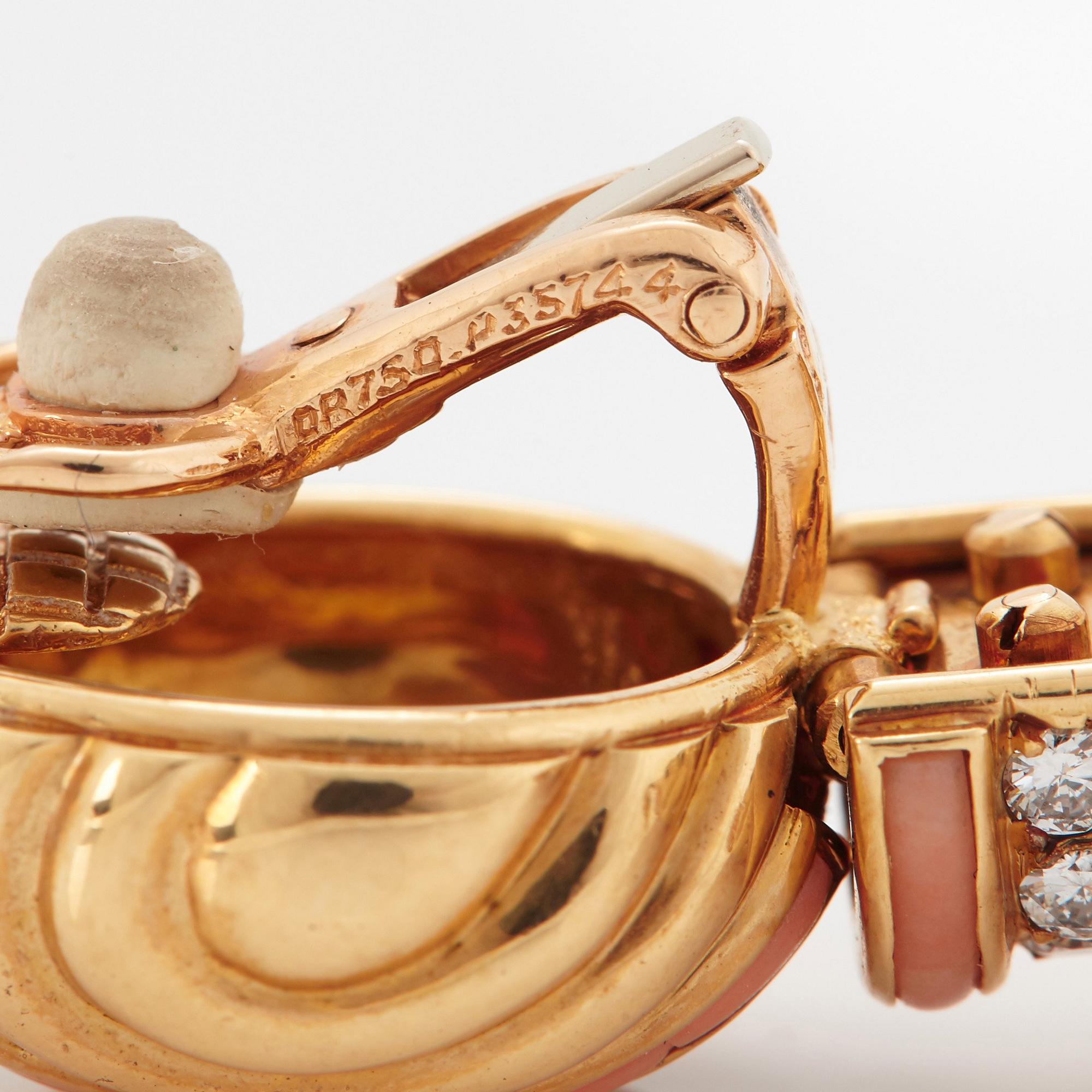 A pair of 18K gold Boucheron earrings set with round brilliant-cut diamonds and coral.
