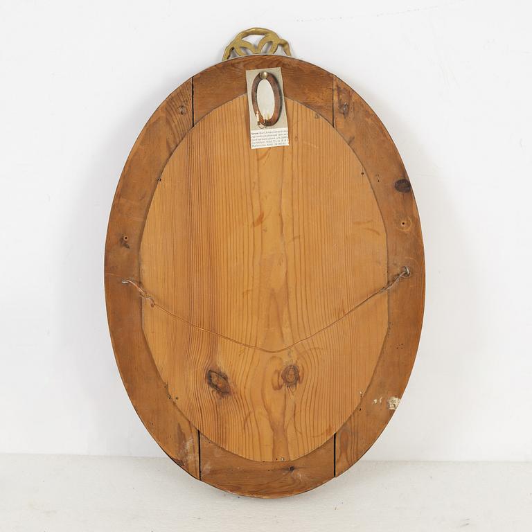 A mahogany veneered mirror sconce, Empire style, around 1900.