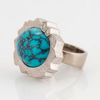 A Grima ring in 14K white gold set with a turquoise and round brilliant-cut diamonds.