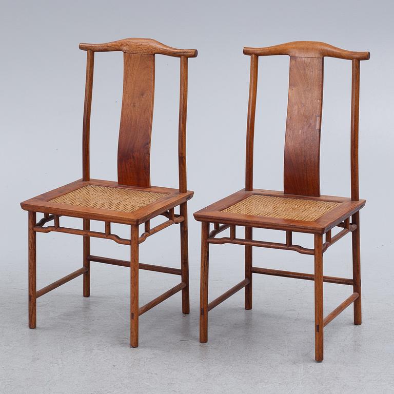 A Chinese hardwood dinner table and ten chairs with rattan seats, 20th century.