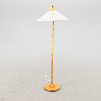 A Markslöjd 21st century wooden floor lamp.